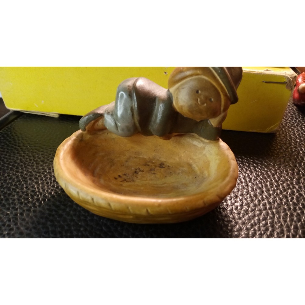 Vintage ceramic trinket dish with boy lounging on the side.